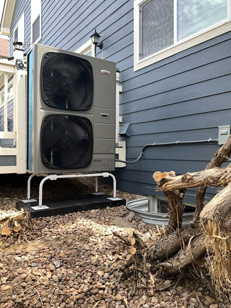 eat pump repair Denver Comfort Crew technician servicing outdoor unit