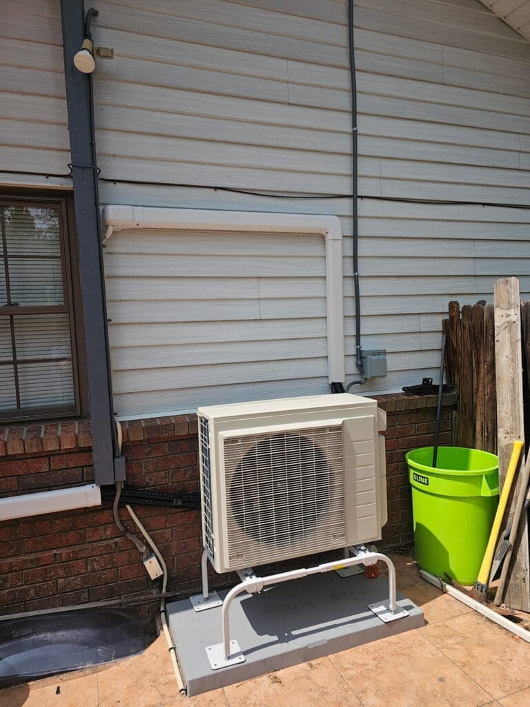 Outdoor cooling system condenser installed beside a Colorado home
