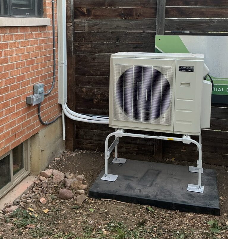 Technician checking a new A/C or heat pump installation to improve airflow, system setup, and long-term HVAC performance in Colorado, all apart of HVAC installation services